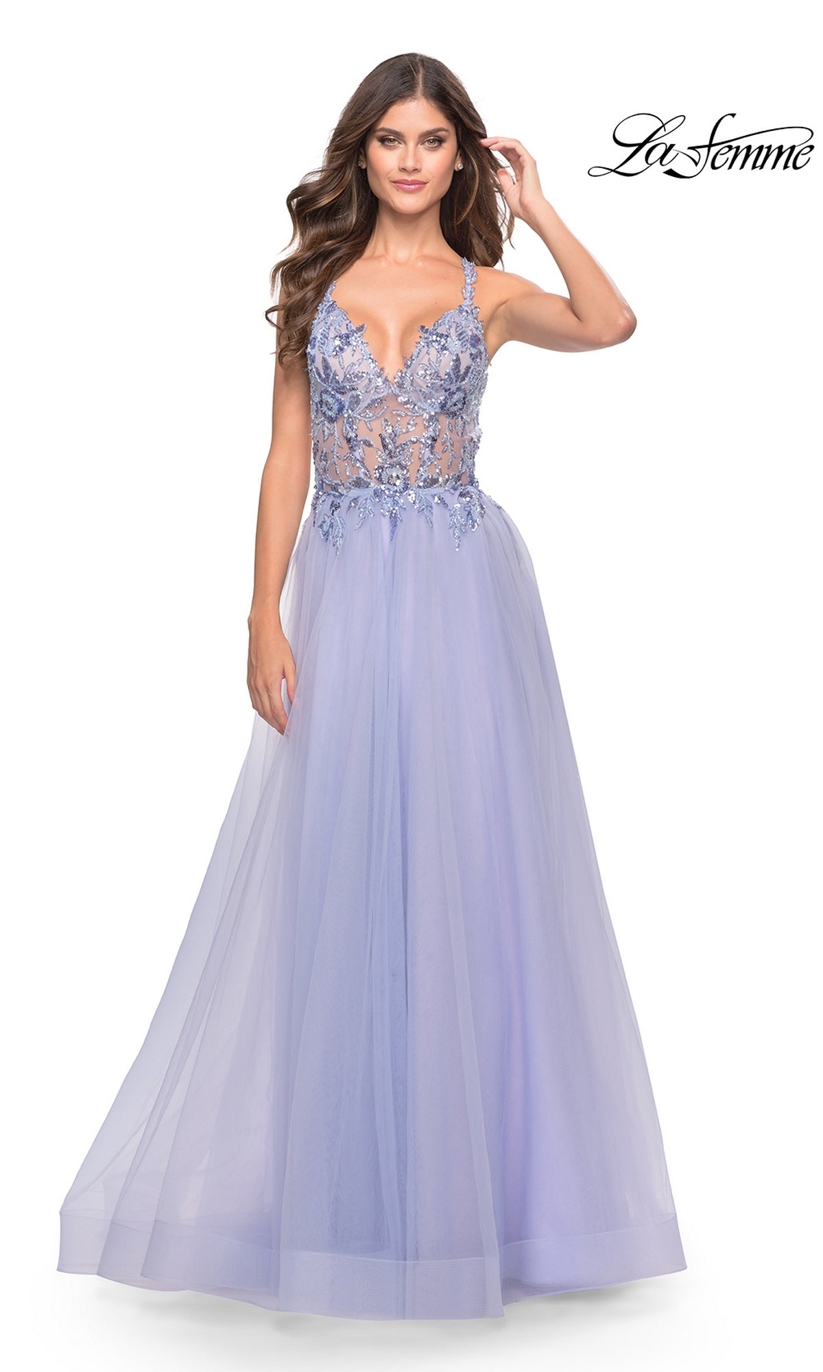A woman wears the La Femme Lace-Bodice Long Prom Dress 31369 in light periwinkle, featuring an embellished lace bodice and flowing skirt. The La Femme logo appears in the upper right corner.